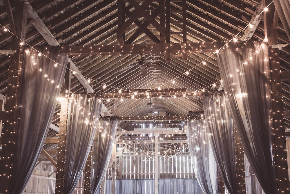 rows of string lights attached to the roof of a building