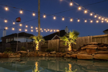 string lights hanging over the pool