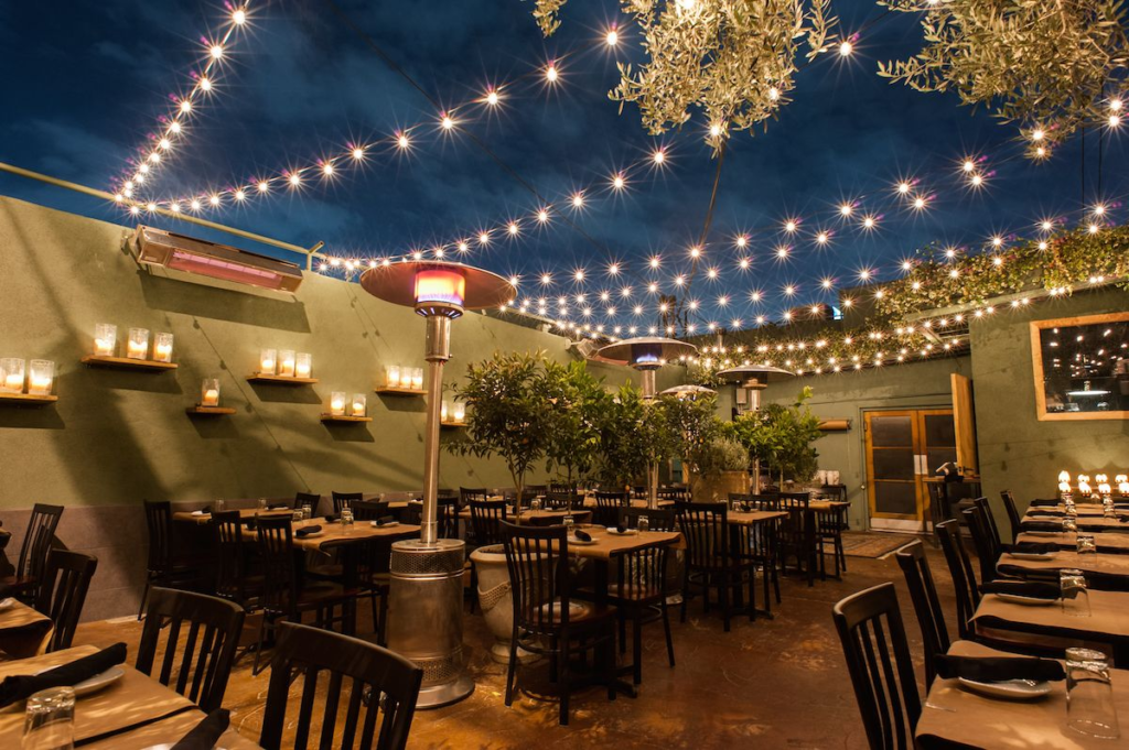 Bistro lights installed over dining tables