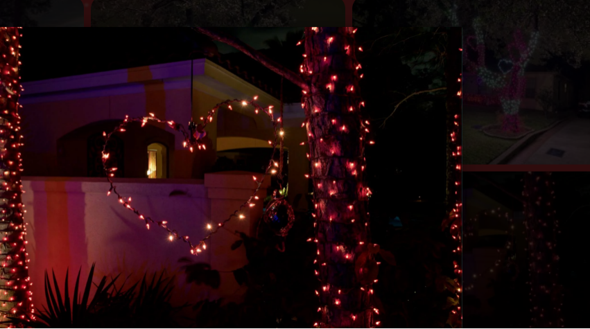 LED heart-shaped holiday lights illuminate trees in a residential display.