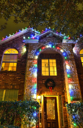 Residential home decorated with professional Christmas lights installation in Houston, showcasing a bright and elegant design.